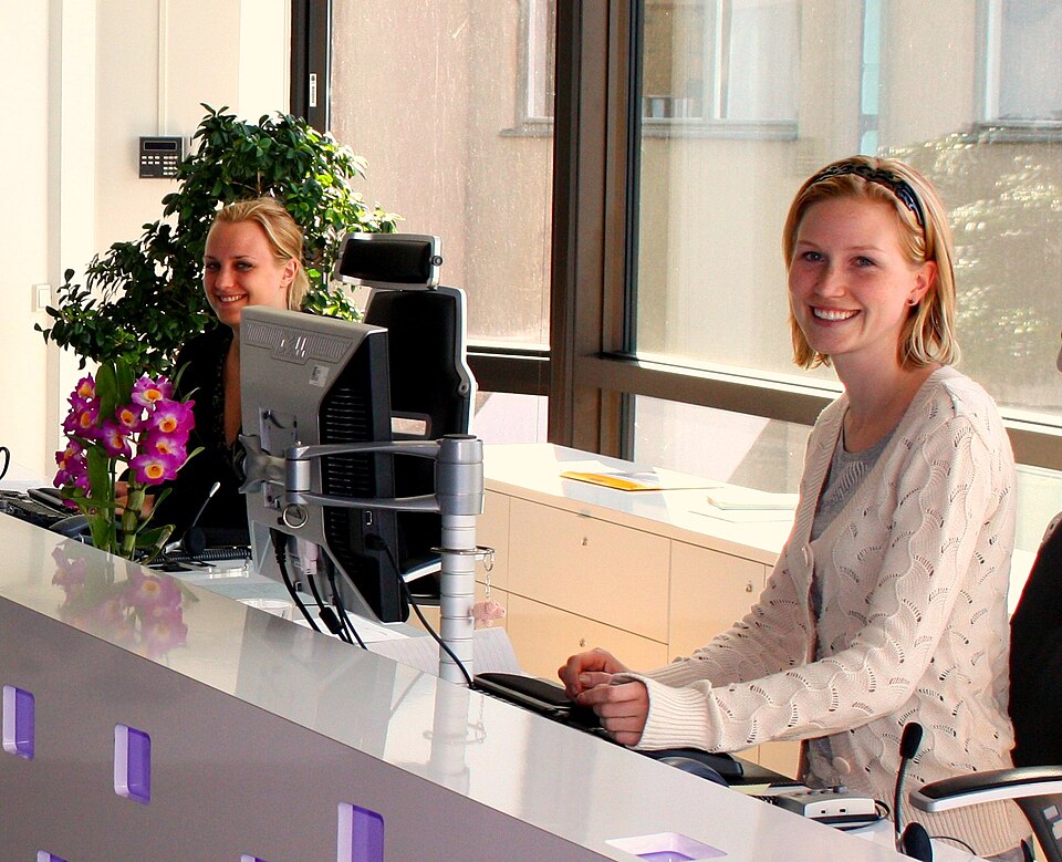 Office receptionist receiving documents